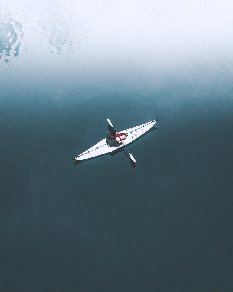 drone shot of a lone kayaker in the water, _early morning adventure 4k