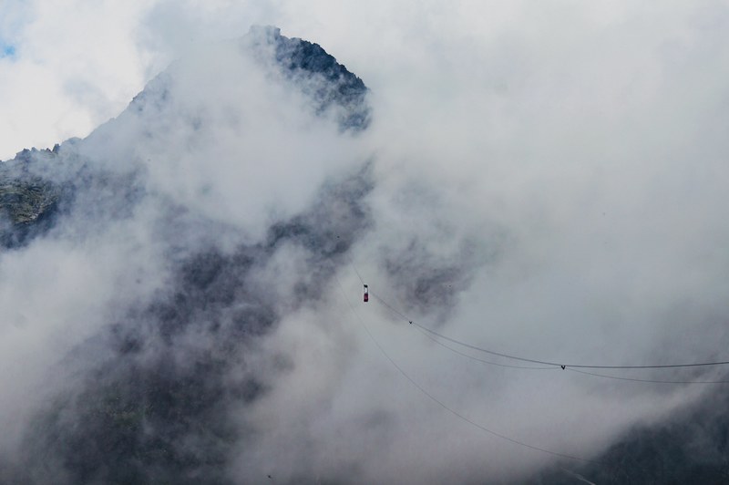 wires strung through tatra mountains on a cloudy foggy day, into the clouds 4k