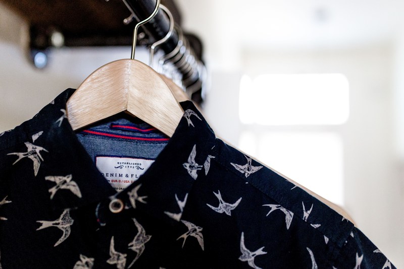 shirts hanging on a clothing pole in a home in san diego, clothing organized at home 4k