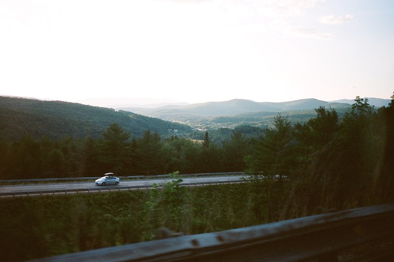 a car on a road along wooded hills in vermont, vermont 4k