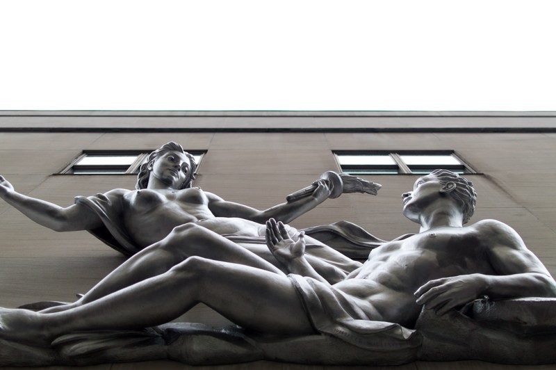 nude art sculptures by a building in the city, stone people 4k
