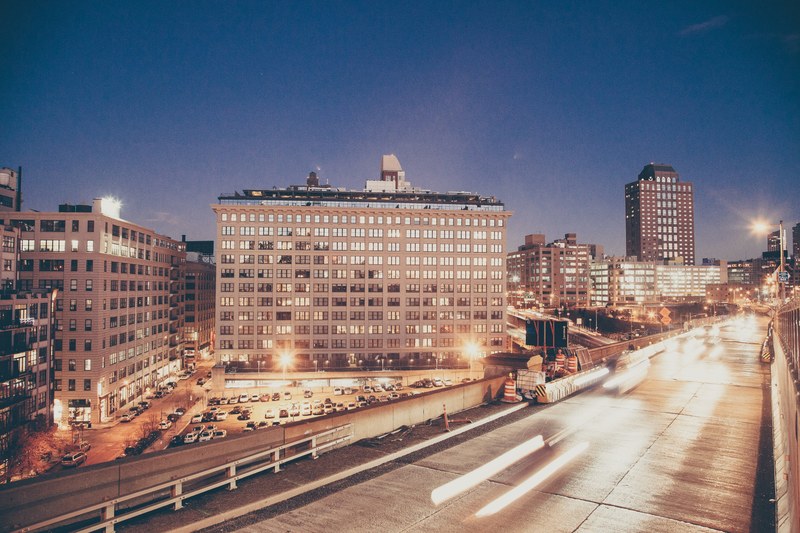 headlights streak across busy streets in a city at night, nighttime traffic 4k