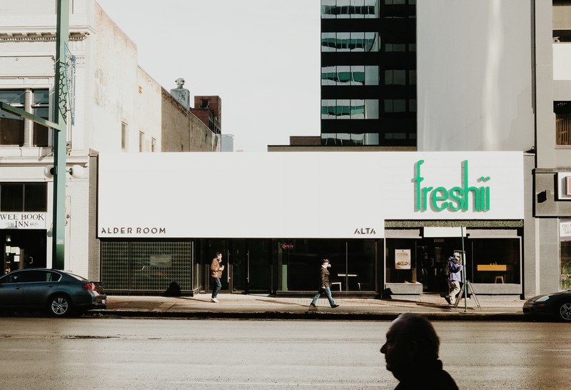 people walking past a storefront in a city, words in context_ time in context 4k