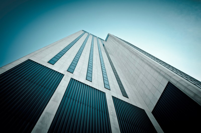 a low angle shot of a white tiled skyscraper facade with small windows, tiled skyscraper facade 4k
