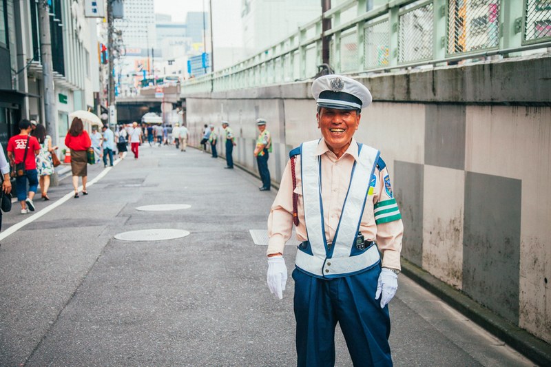 a smiling traffic cop on the street in shinjuku japan, shinjuku 4k