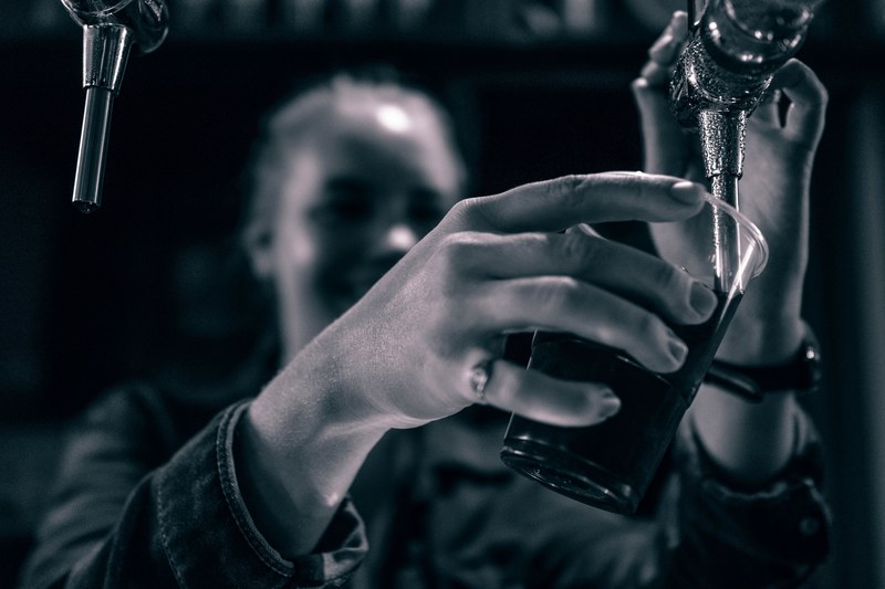 a bartender pouring beer into a glass at equity point gothic, sangria time 4k
