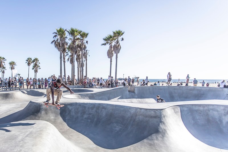 a man doing skateboard tricks at venice beach skate park in los angeles california, venice beach skate park 4k
