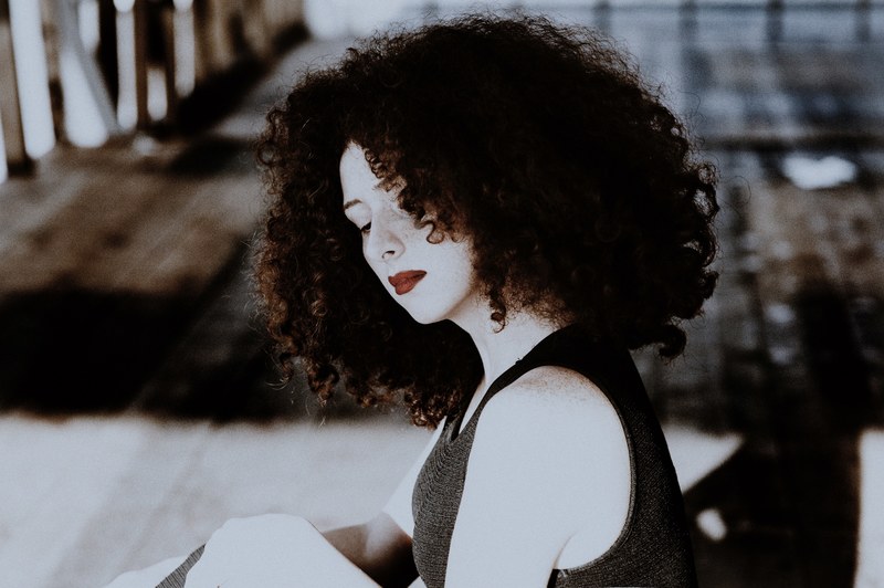 portrait of a woman with curly dark hair and dark red lipstick, red and white with curlyhair 4k