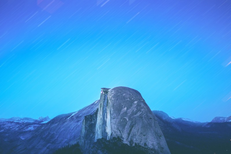 a look at a blurry blue sky with stars shooting over yosemite national park, always in motion 4k