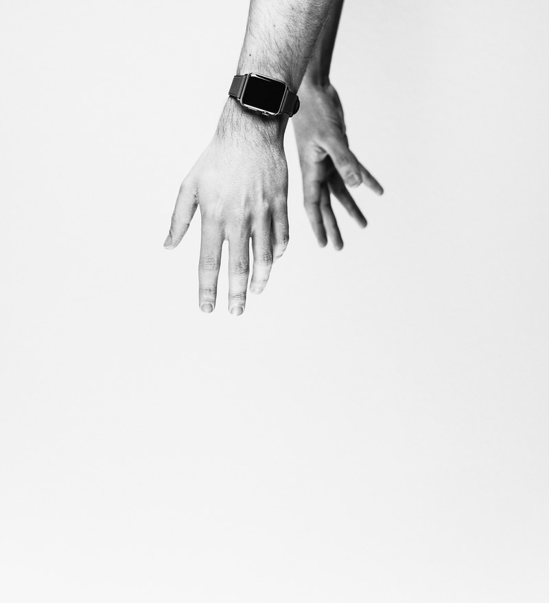 the hands of a person wearing an apple watch in black and white, hands in monochrome 4k