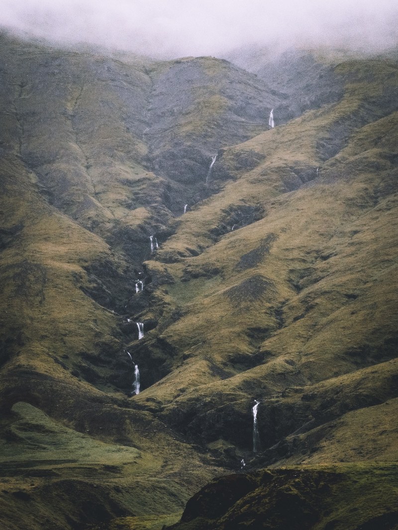line of waterfalls in the green grassy mountains of iceland, waterfalls in iceland 4k