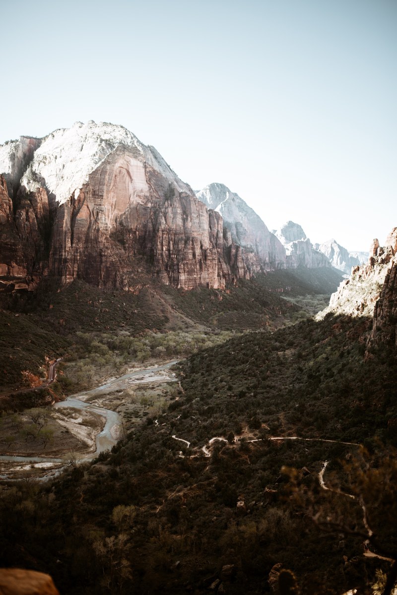 view of a valley in zion national park with a river flowing on its floor, on the way up to angels landing 4k
