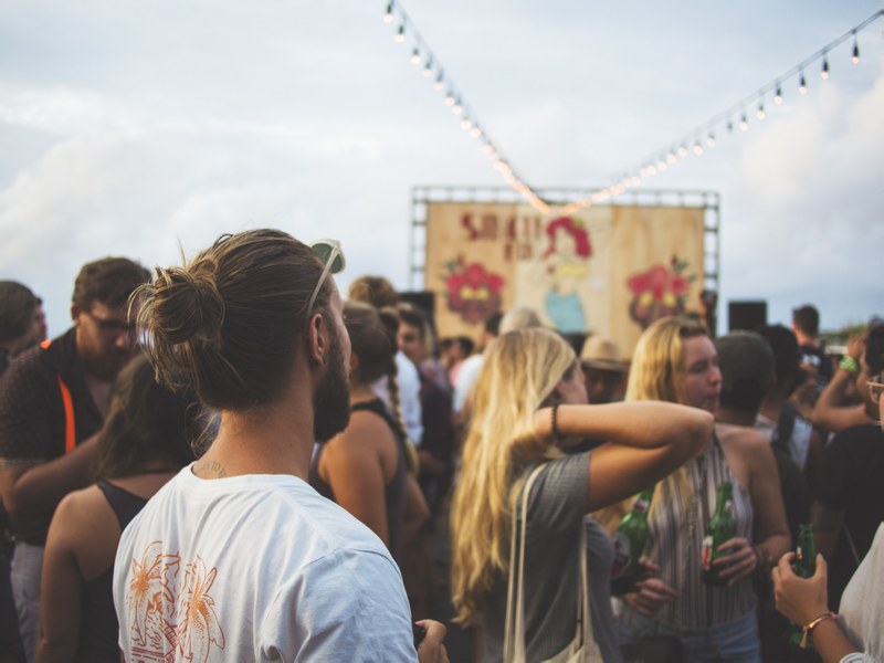 back view of a man with long hair and beards standing in a crowd, man standing in a crowd 4k