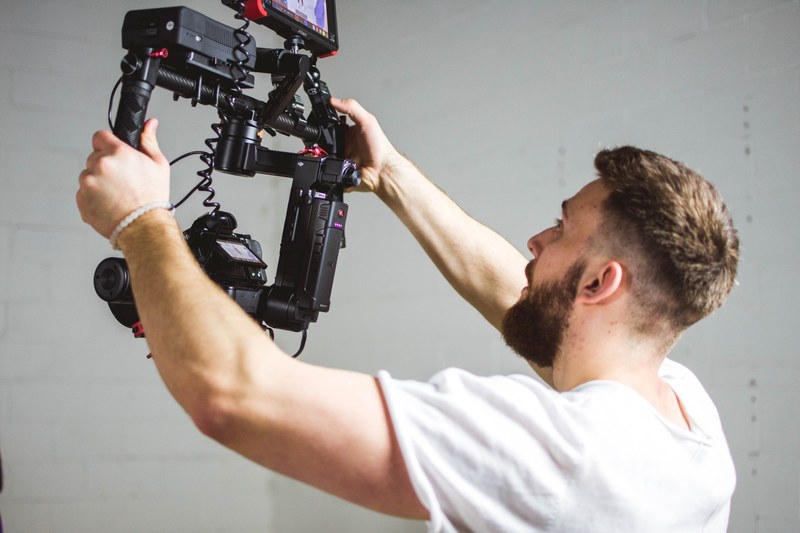 man films something with a camera rig in laval, laval man and camera rig 4k