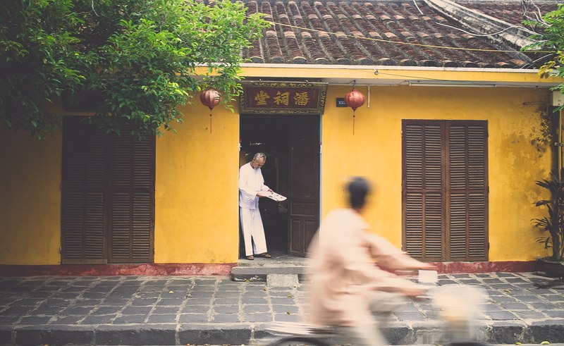 asian house with a man in the door and another man on a bike driving by, asian house 4k