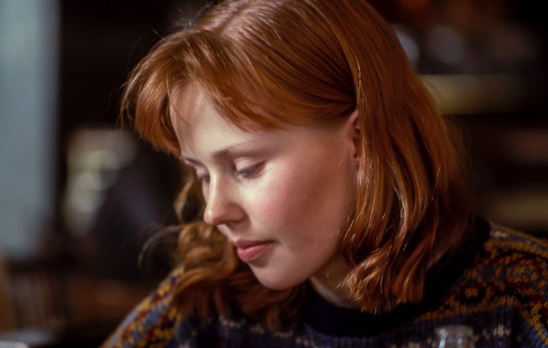 woman with red hair and bangs smiling and looking down, retro bangs 4k