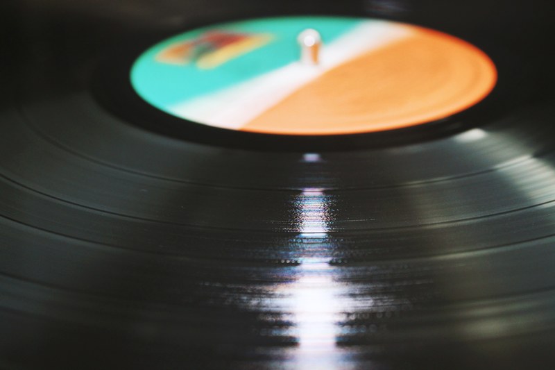 a close up of the spinning surface of a vinyl record, spinnin record 4k