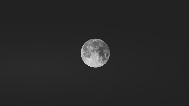 a focused shot on a full moon in a dark night sky in innsbruck austria, the perfect moment 4k