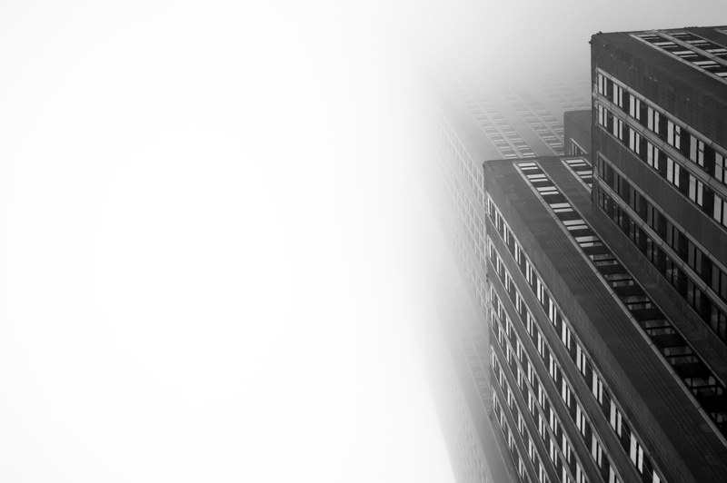 the towering empire state building shrouded in thick fog, skyscraper in clouds 4k