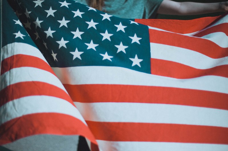 a person holding an american flag, person holding american flag 4k
