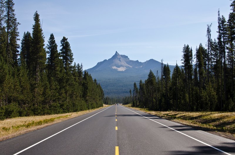 a two lane road heading towards a mountain with trees on either side, mt_ thielsen oregon 4k