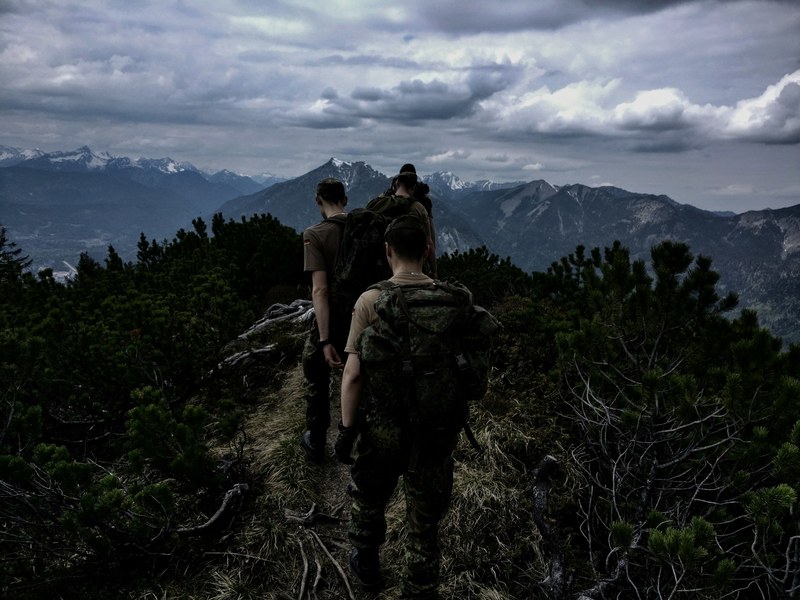 army men hiking in the mountains and green forest in wank, wank army hike 4k