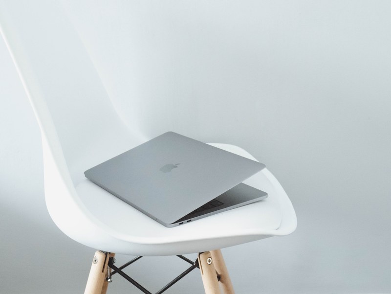 a half closed macbook on a white chair, i bought a 2017 mac pro_ 4k