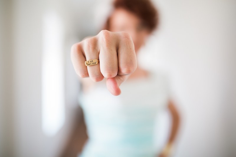 a persons clenched fist with an engraved ring with the phrase quoti am badassquot, i am badass 4k