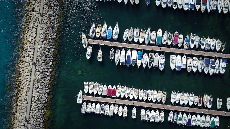 a drone shot of boats moored at a marina in marseille, aerial view of a marina 4k