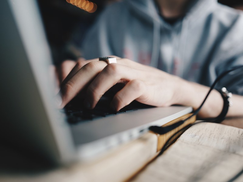 close up of a persons hands on a laptop keyboard, working on a laptop 4k