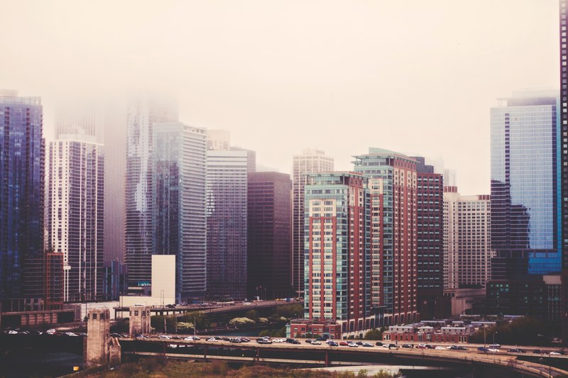 high rises in a city on a misty day, skyscrapers in fog 4k