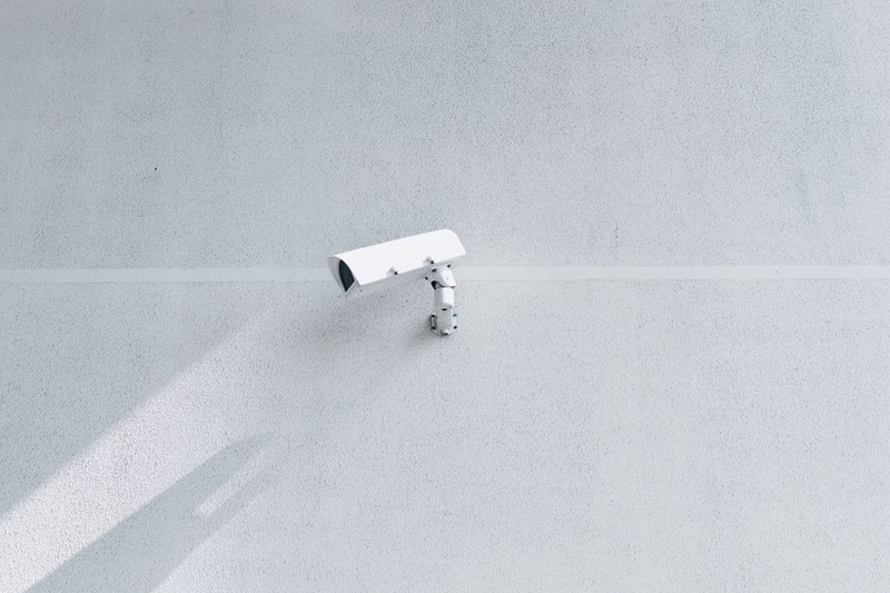 a white surveillance camera casts a shadow on a blank white wall, surveillance camera shadow 4k