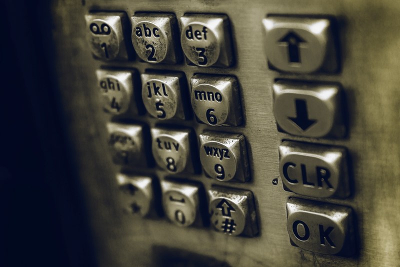 close up of a payphone keypad, macro payphone numbers 4k
