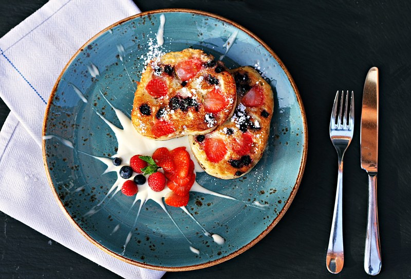 gourmet plate of french toast with berries and cream for breakfast, splash of vanilla 4k