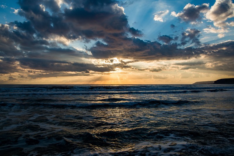 view of the sun shining through clouds from the kourion beach, sunset sea and sky 4k
