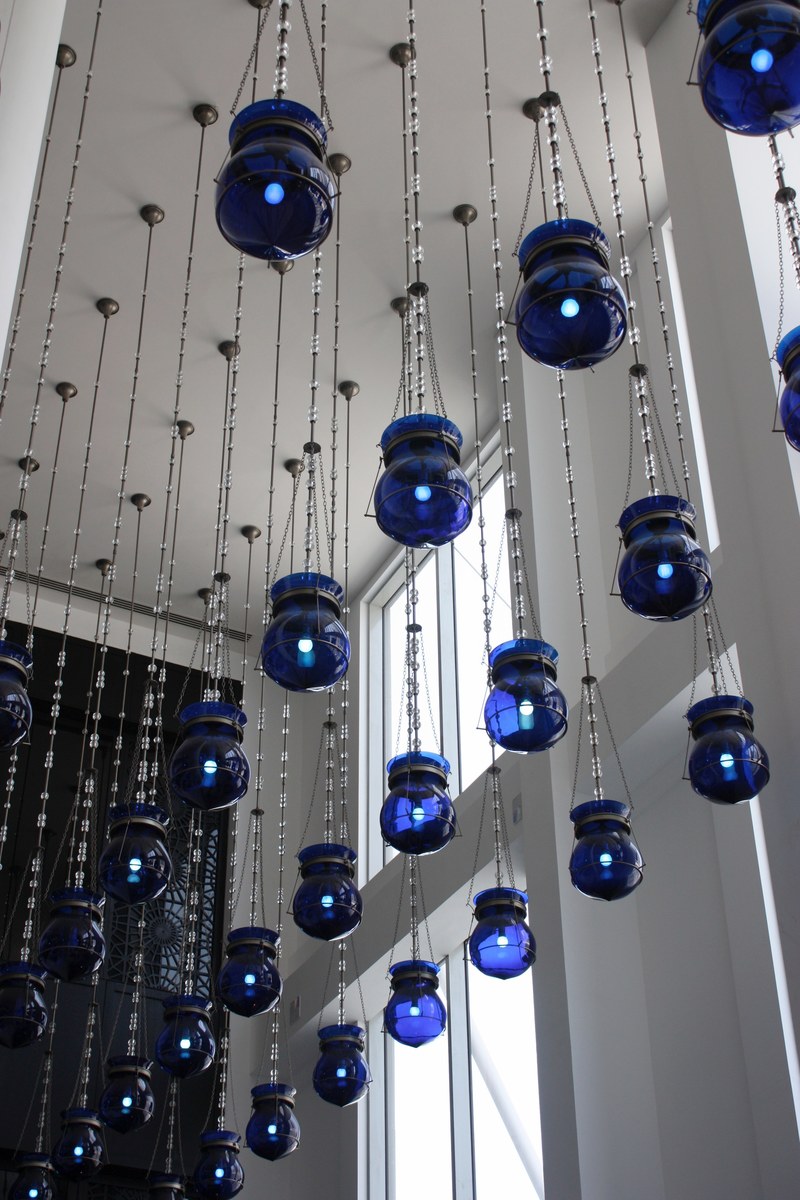blue lanterns hanging from the ceiling in a white tall room, blue lanterns hanging from ceiling 4k