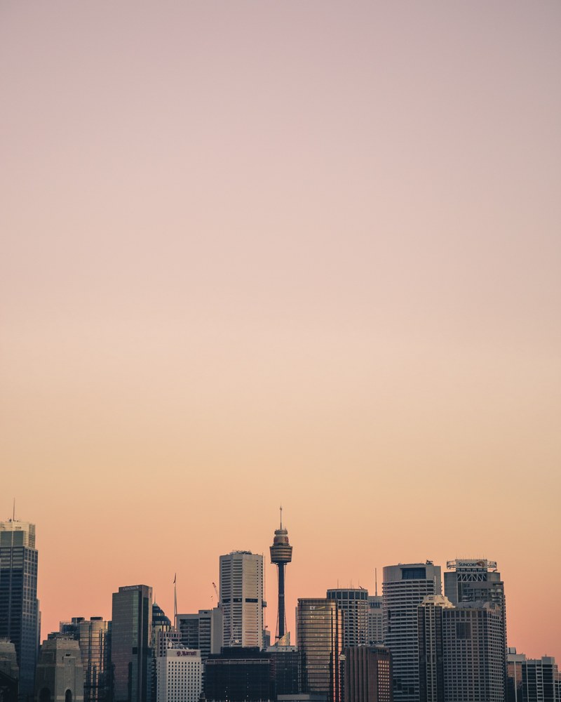 a dusky sky over the skyscrapers of sydney, orange tint 4k