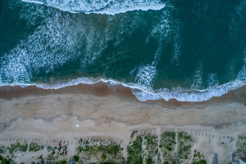 Drone View Of The Ocean Washing On A Sand Shoreline At Nags Head North 