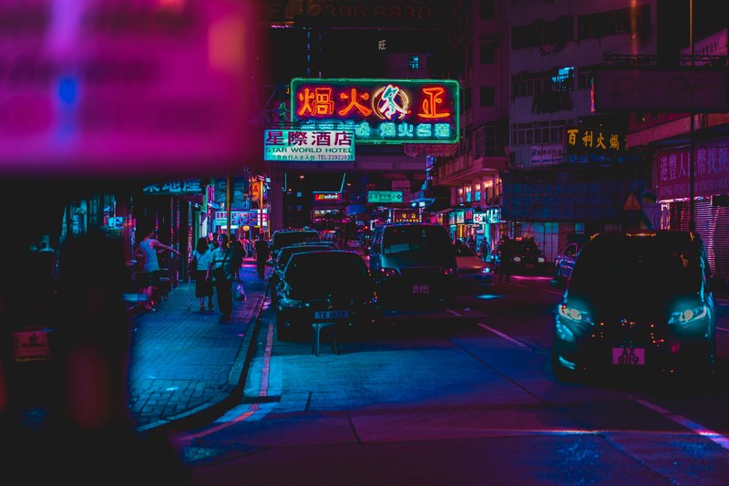 hong kong street at night with neon signs and lights reflecting off of cars, hong kong night street 4k