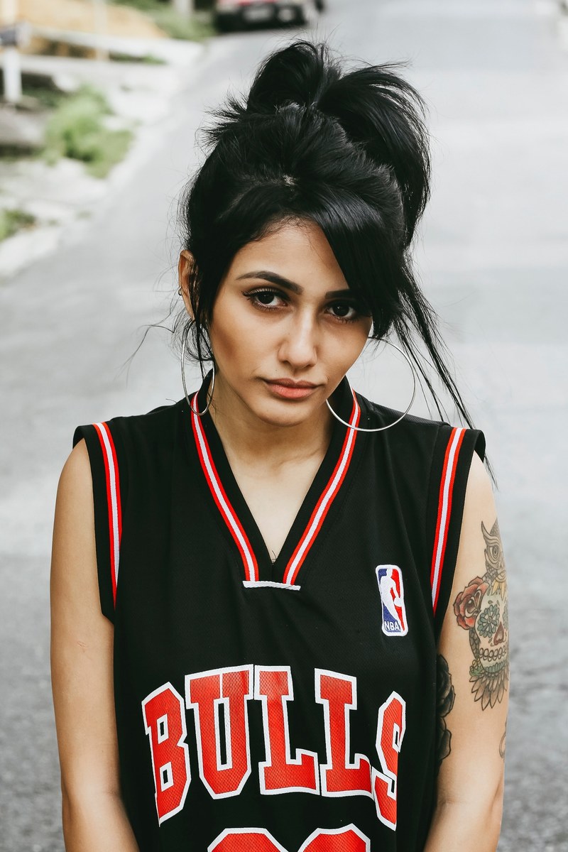woman in a retro bulls basketball jersey and hoop earrings, bulls jersey 4k