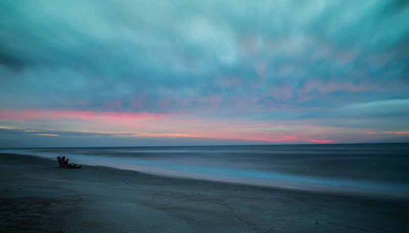 people on the sandy beach after the sunset at saint augustine beach, watercolor summer sunrise 4k