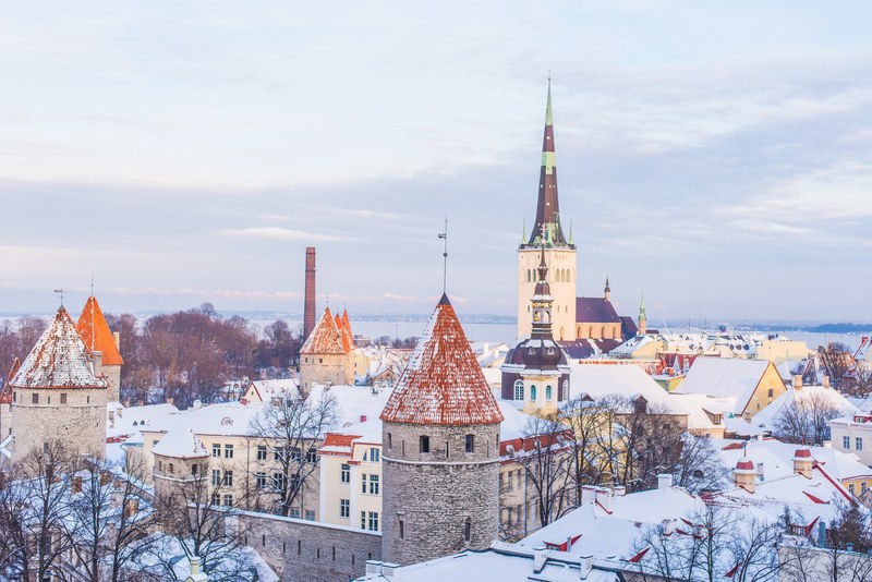 a drone shot of a snow covered city on a winter day, city covered in snow 4k