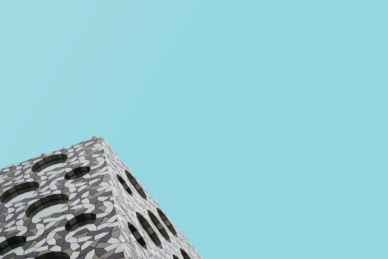 abstract mosaic facade of a modern building with circular windows against the blue sky in london, _abstract mosaic facade london 4k
