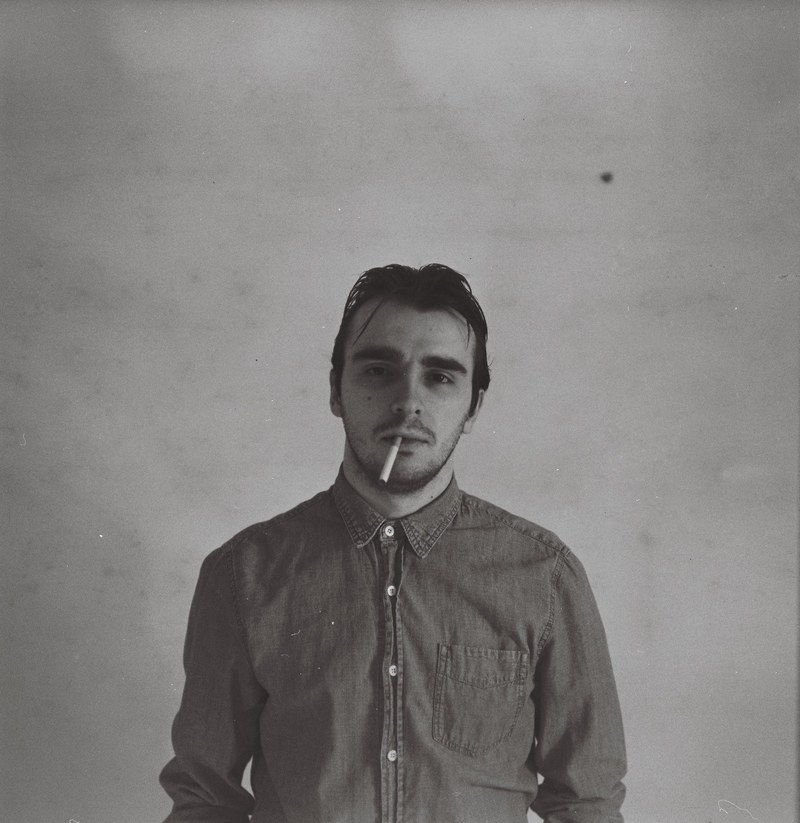 retro portrait of a man smoking an unlit cigarette, smoking a cigarette 4k