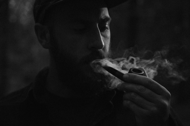 black and white shot of man in cap smoking pipe in newport state park, newport male pipe smoker 4k