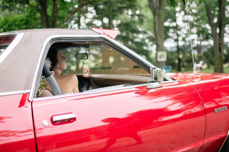shiny red vintage car with a woman seen through the passenger window, _red vintage car 4k
