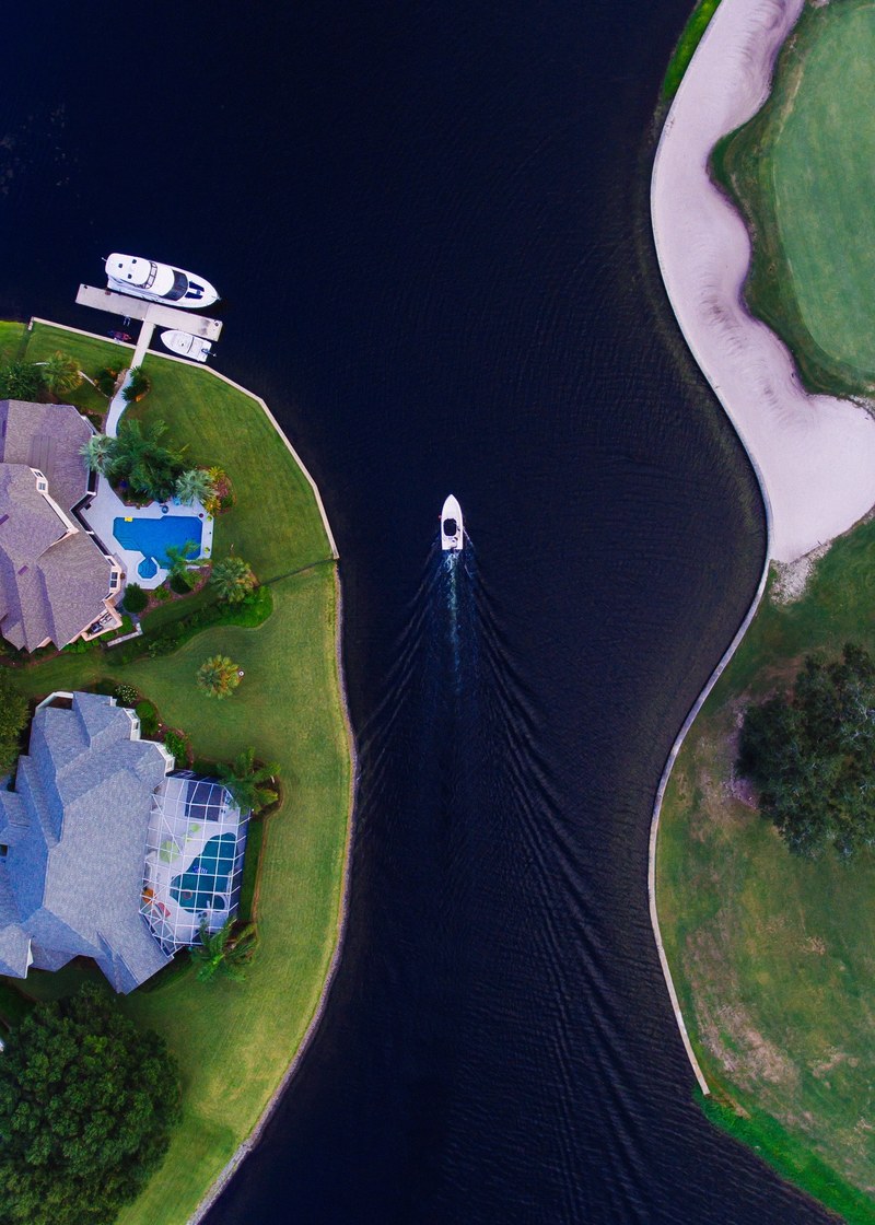 a drone view of a waterfront neighborhood of mansions and boats in arlington jacksonville florida united states, arlington jacksonville mansion 4k
