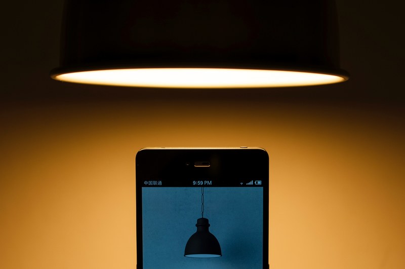 lamp hangs above cellphone that displays a photo of a lamp, lamp on phone under lamp 4k