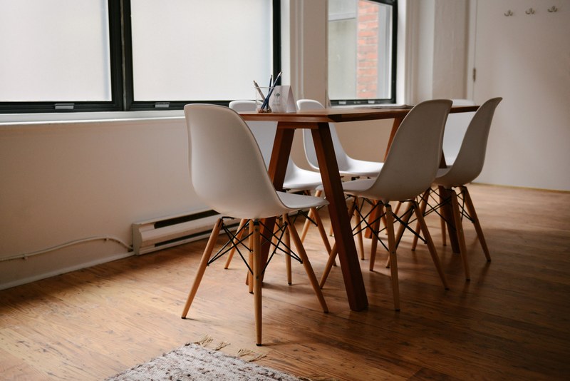 an interior of a meeting room stocked with modern wooden chairs and table in an office space, chairs in a meeting room 4k