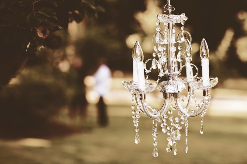 a crystal chandelier hangs in a garden, _crystal chandelier garden 4k